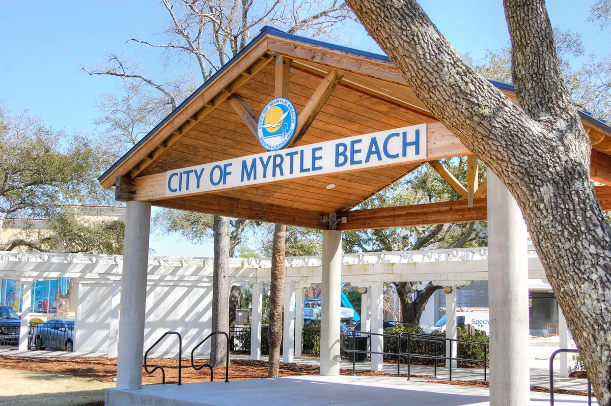 This photo captures a welcoming Myrtle Beach entrance sign with a wooden structure and surrounding trees, creating a sense of arrival and local charm. The relaxed, open setting encourages exploration and sets the tone for coastal adventures.